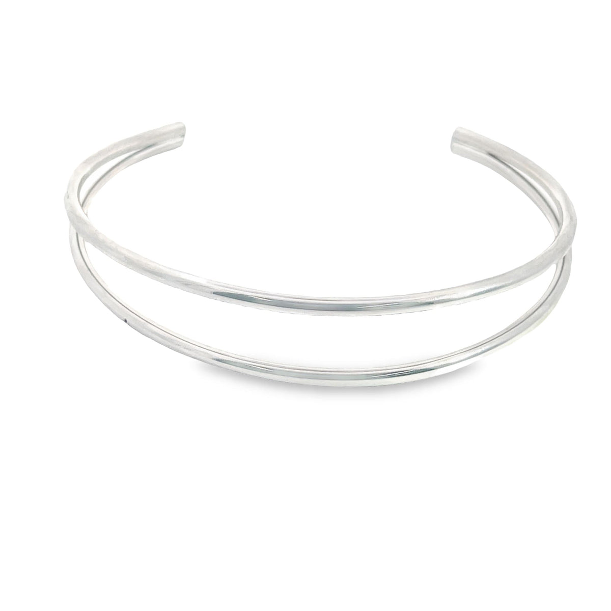 A sleek silver double-band cuff bracelet rests on a clean white background.