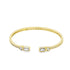 A sleek gold cuff bracelet sparkles with baguette and round CZ stones against a clean white background.