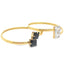 Two minimalist gold open-toie rings display contrasting square-cut black and white stones on a clean white background.