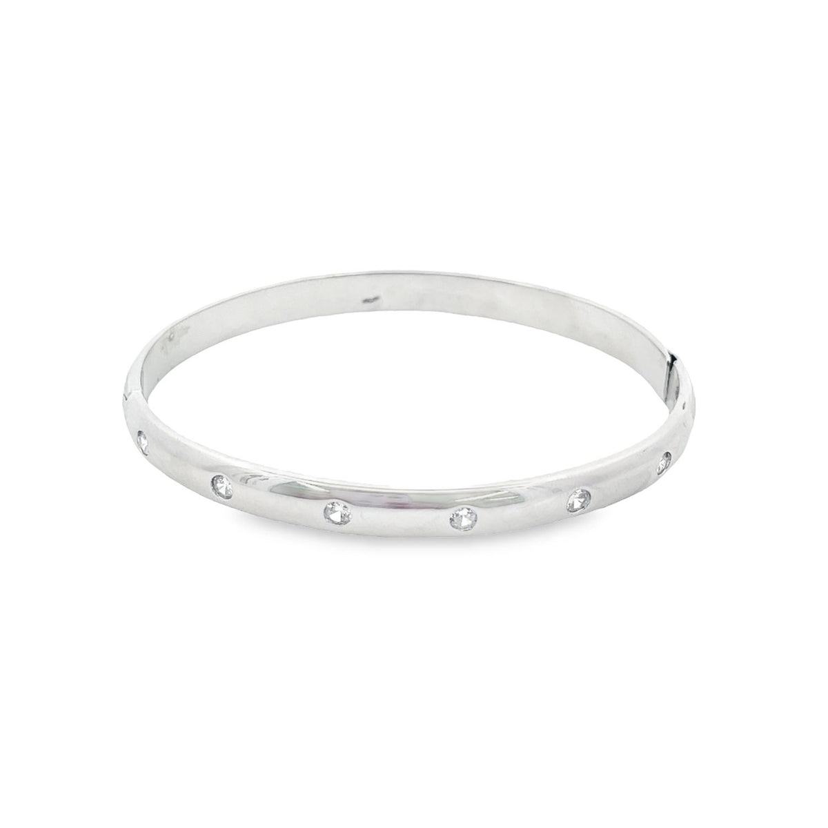 A sleek silver bangle bracelet features flush-set sparkling diamonds spaced evenly along its polished band.
