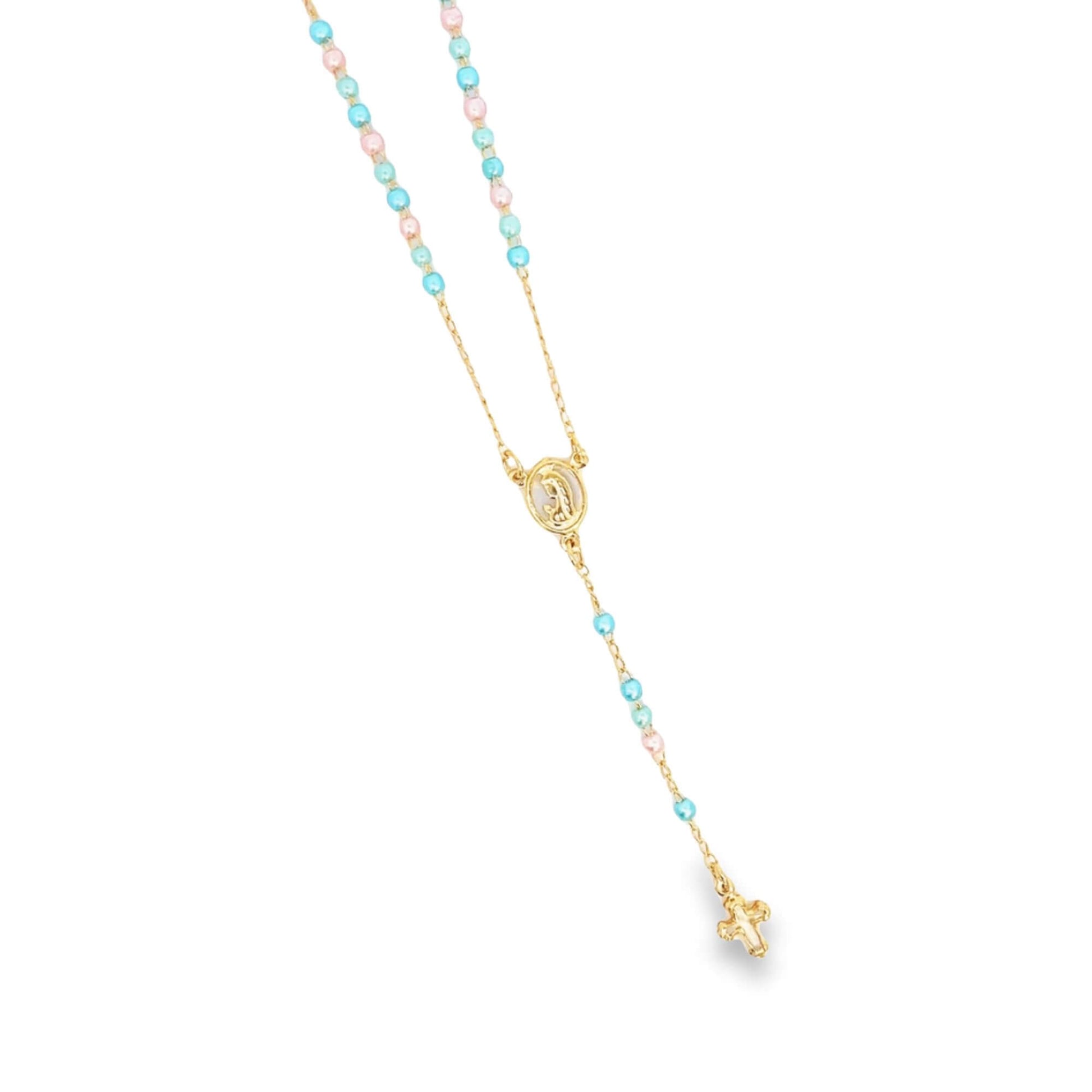 A delicate gold rosary necklace features alternating pastel blue and pink beads, a central centerpiece, and a small crucifix dangling against a plain white background.
