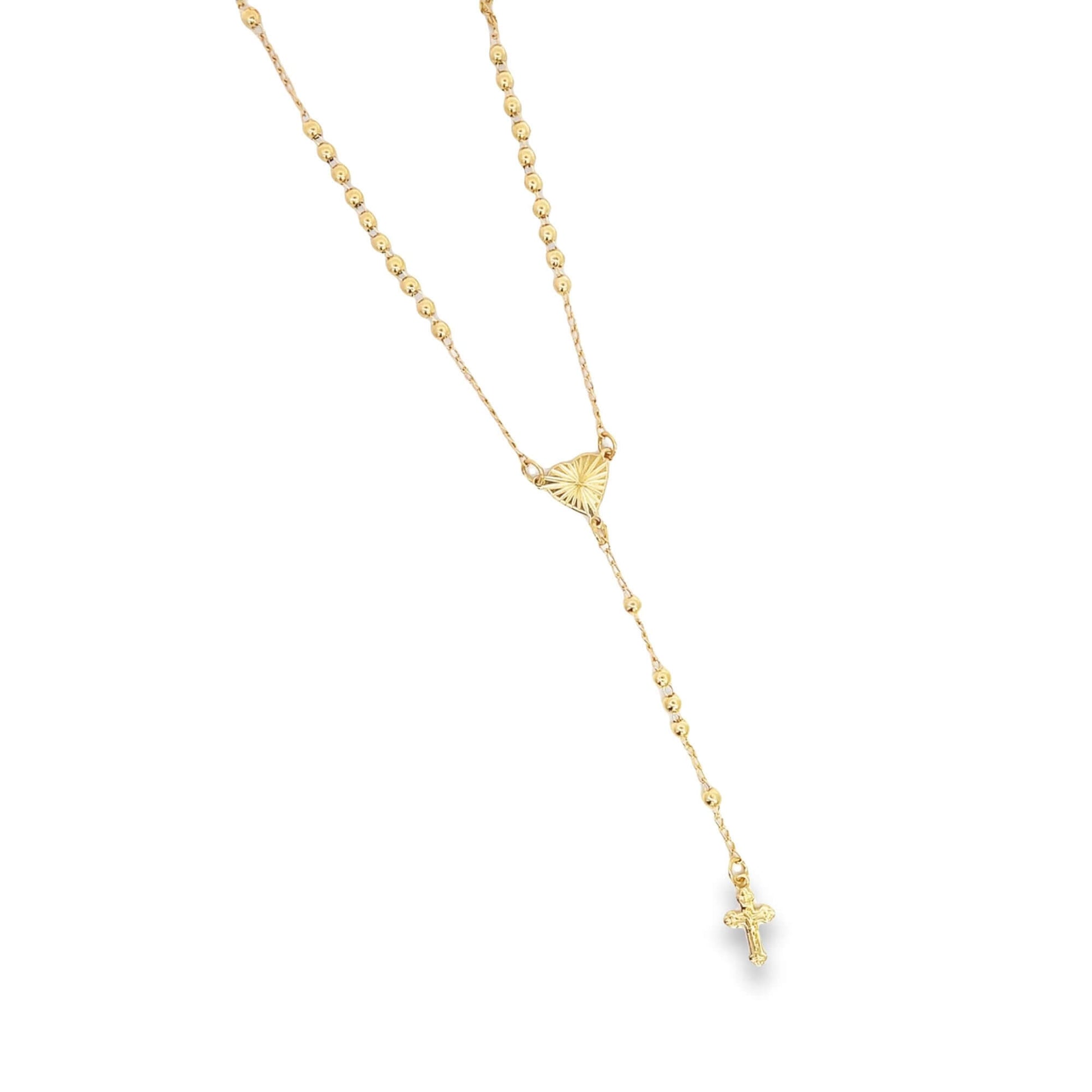 A delicate gold rosary necklace features polished beads, a textured heart-shaped center, and a small crucifix pendant against a plain white background.