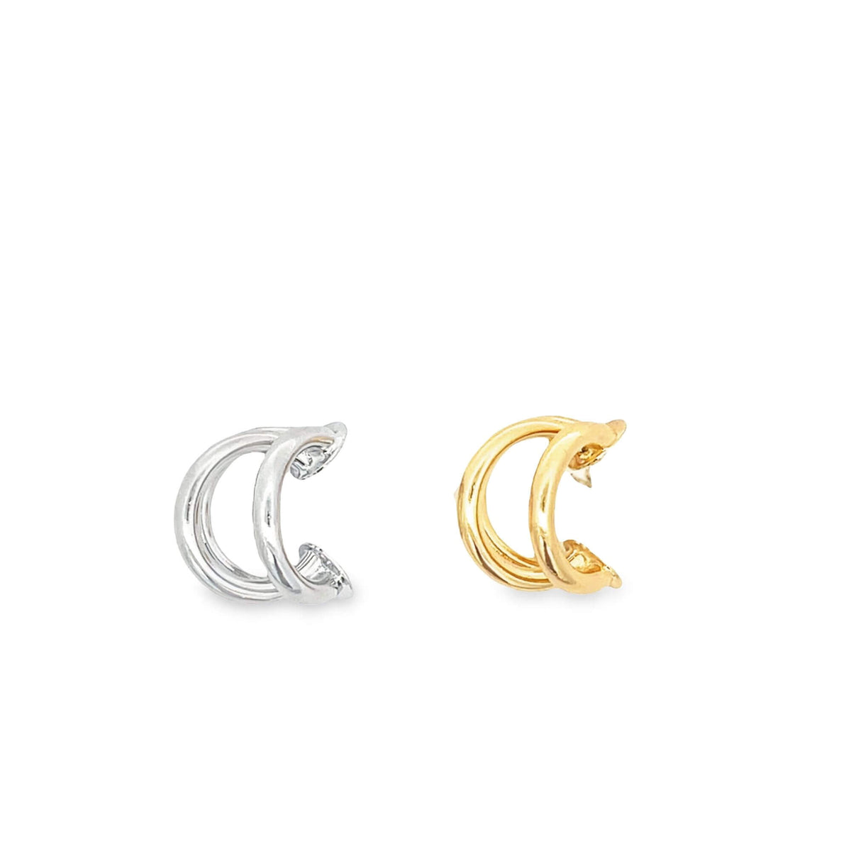 A pair of sleek triple-band hoop earrings sits side-by-side on a white surface, showcasing one silver and one gold finish.