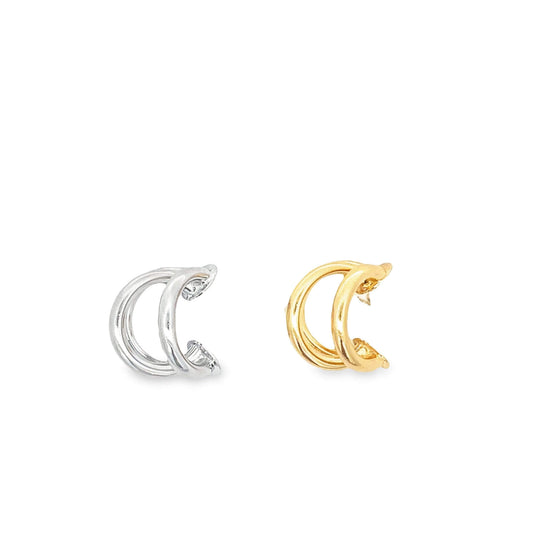 A pair of minimalist double-band hoop earrings, featuring one silver and one gold design, rests side by side against a white background.