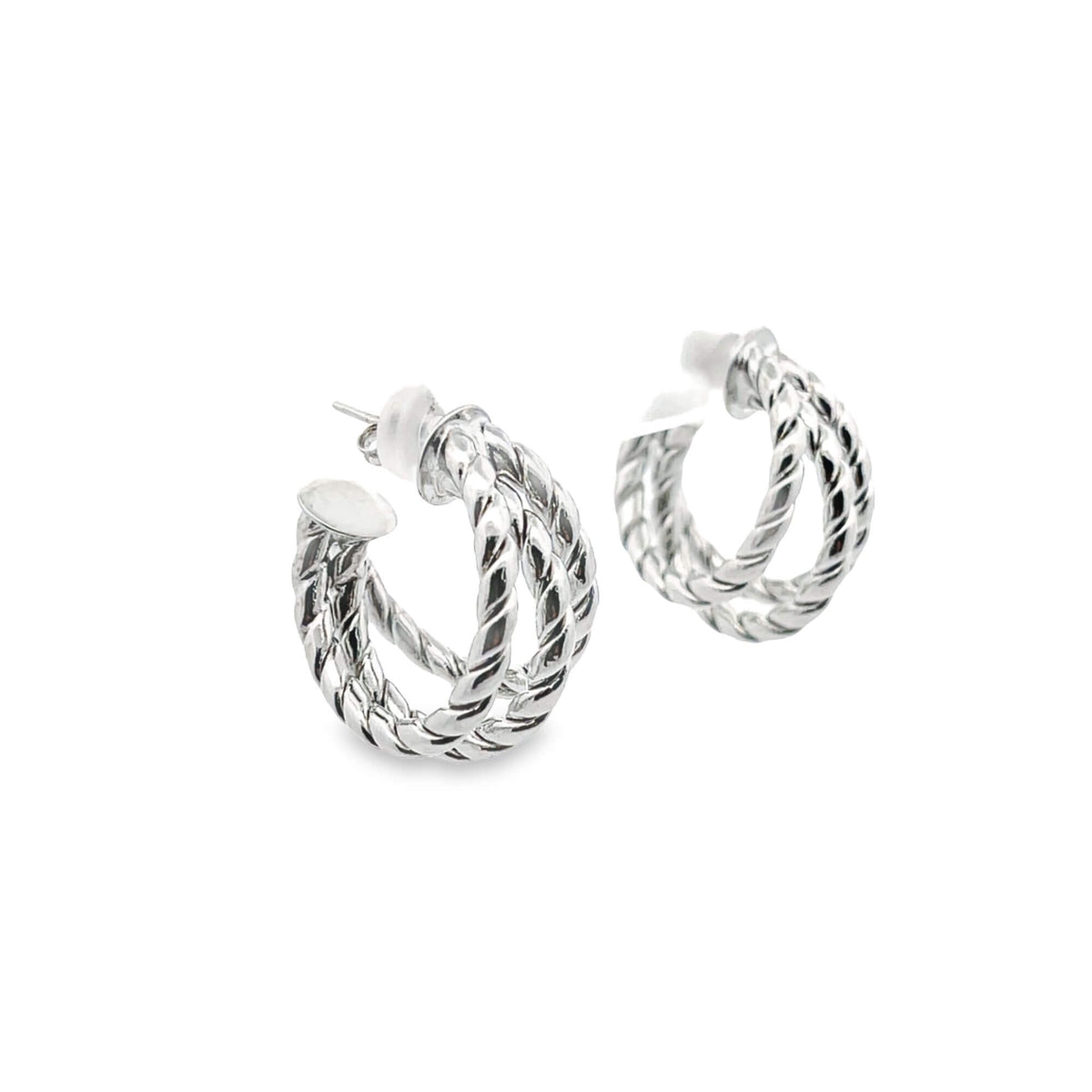 A pair of silver twisted rope hoop earrings rest against a clean white background.