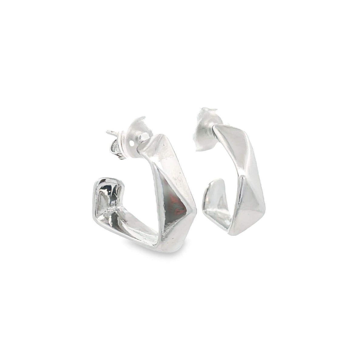 A pair of geometric silver hoop earrings rests against a clean white background.