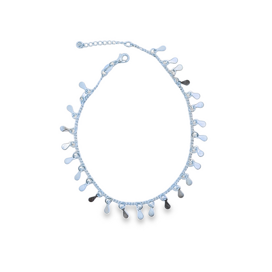 A delicate silver chain anklet dangles charming little teardrop charms against a clean white background.
