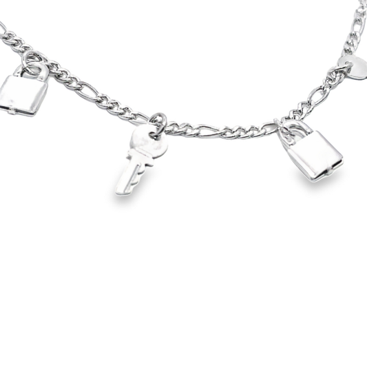 A delicate silver charm bracelet displays dangling lock and key charms against a clean white background.