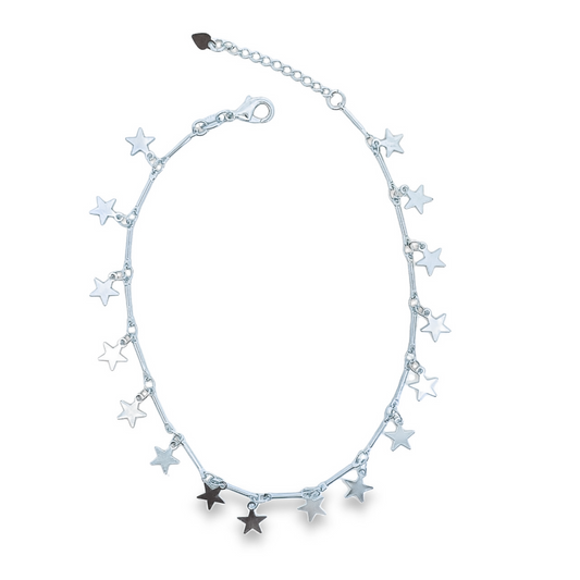 A delicate silver star charm anklet curves against a clean white background.