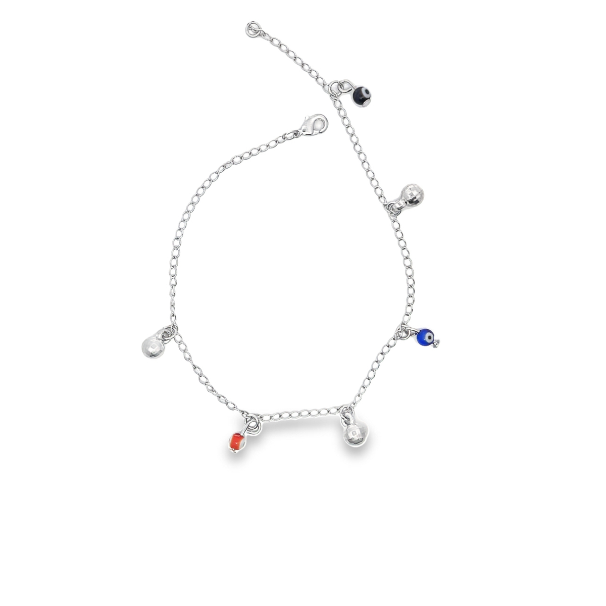 A silver charm anklet displays dangling evil eye beads and small metallic spheres against a plain white background.