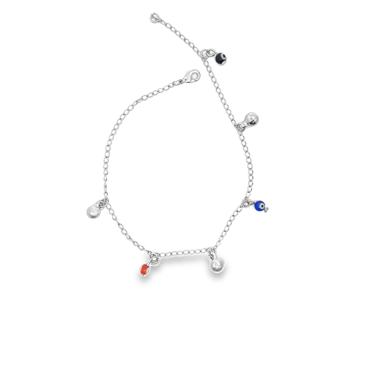 A delicate silver charm anklet features dangling evil eye beads and metallic spheres against a plain white background.