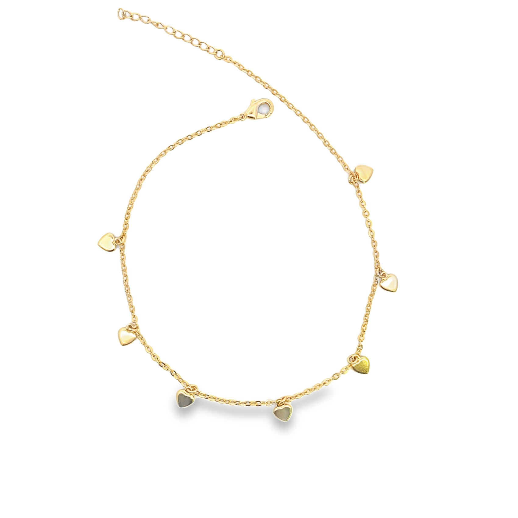 A delicate gold chain anklet adorned with hanging heart charms lies displayed against a clean white background.