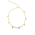 A delicate gold chain anklet adorned with hanging heart charms lies displayed against a clean white background.
