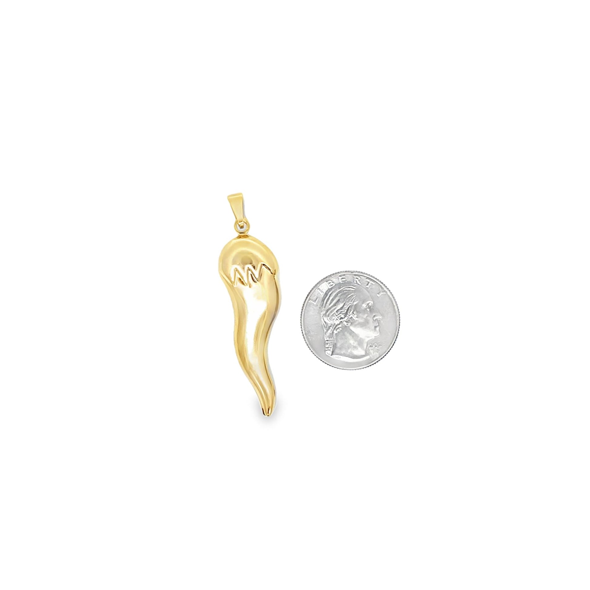 A polished gold Italian horn pendant rests beside a US quarter for scale.
