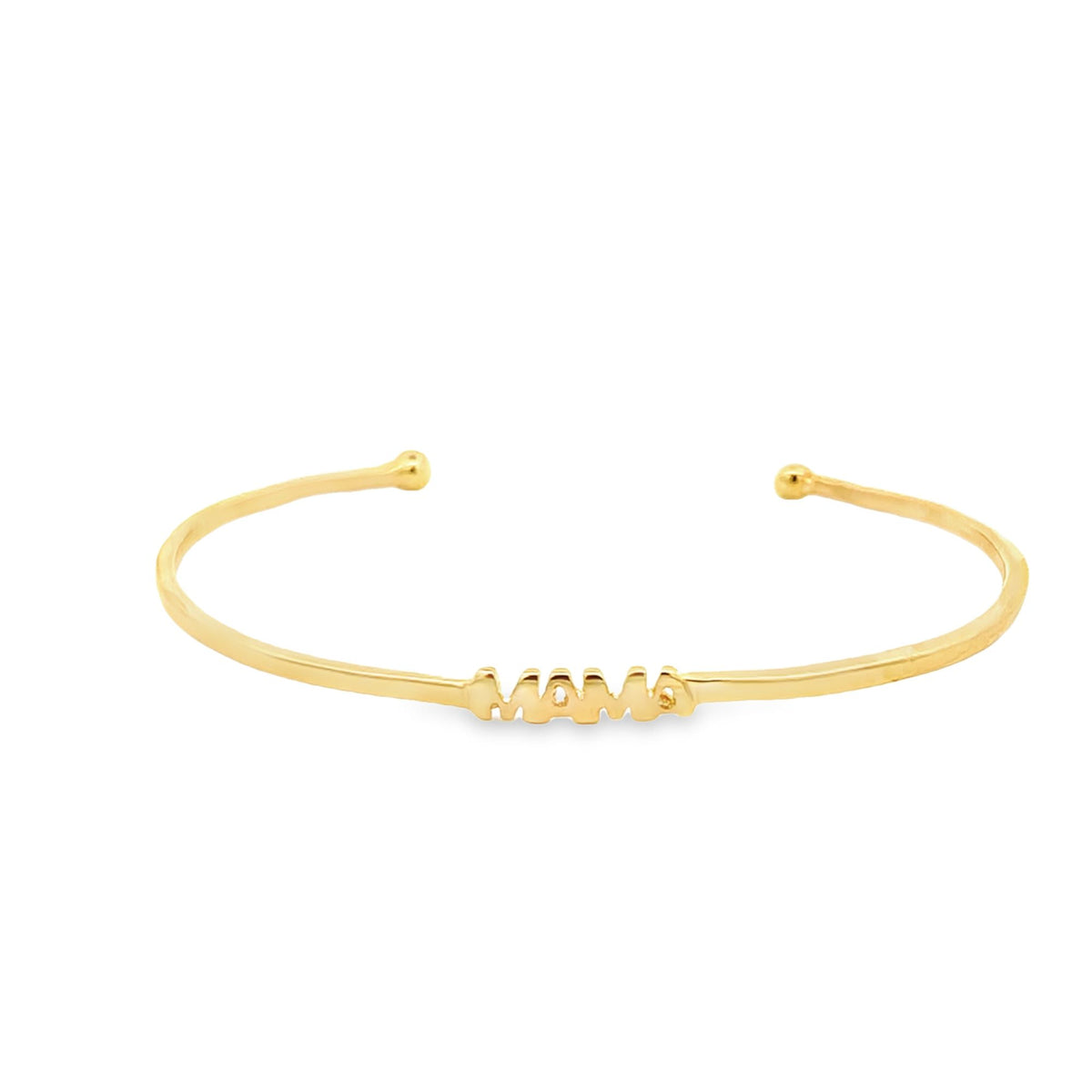 A sleek gold cuff bracelet displays the word "MAMA" centered across the front against a clean white background.