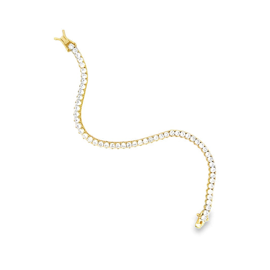 A gold tennis bracelet sparkles with round-cut cubic zirconia stones arranged in an elegant, wavy line against a clean white background.