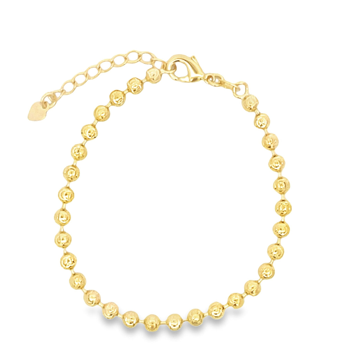 A delicate gold bead bracelet curves gracefully against a plain white background, featuring an adjustable chain with a tiny heart charm.
