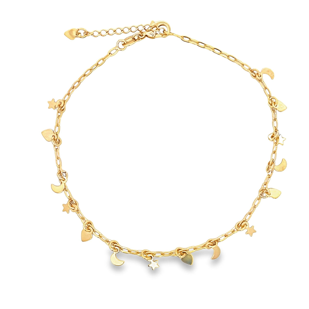 A delicate gold charm anklet features dangling star, moon, and heart charms along its chain.