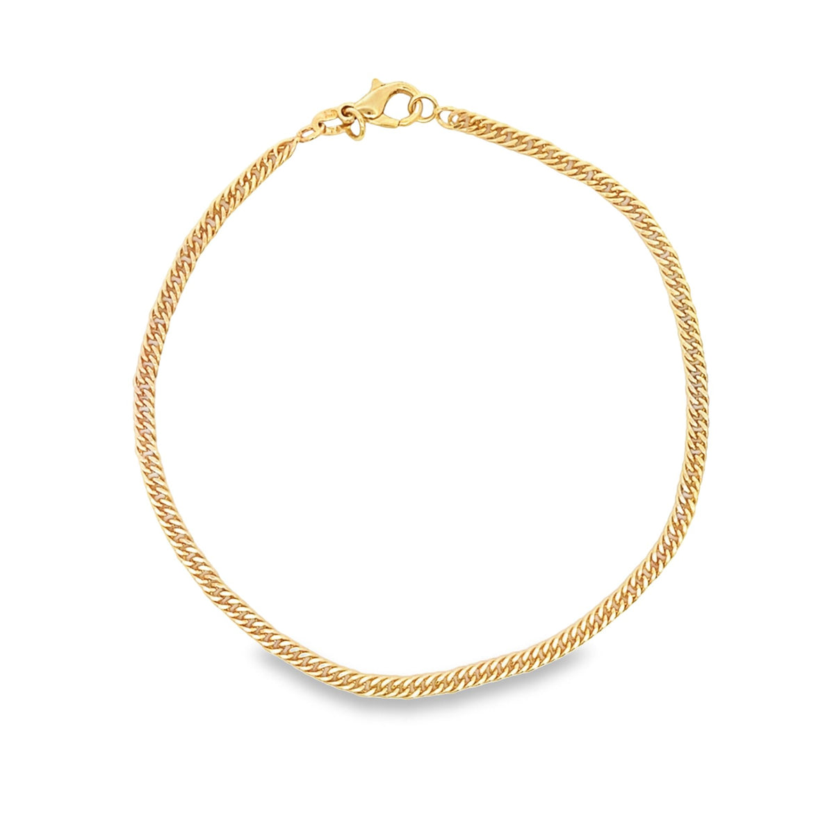 A shiny gold curb chain necklace forms a circle against a white background.