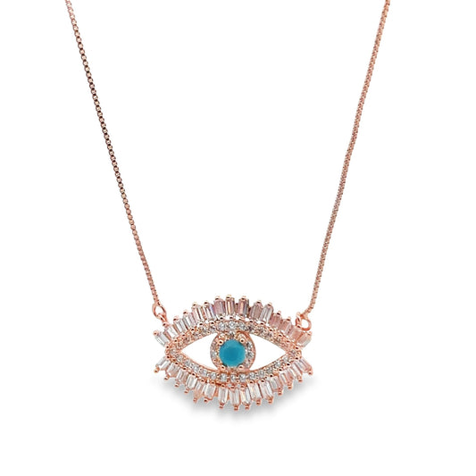 A delicate rose gold evil eye necklace features a central turquoise stone surrounded by sparkling baguette and pavé diamonds.