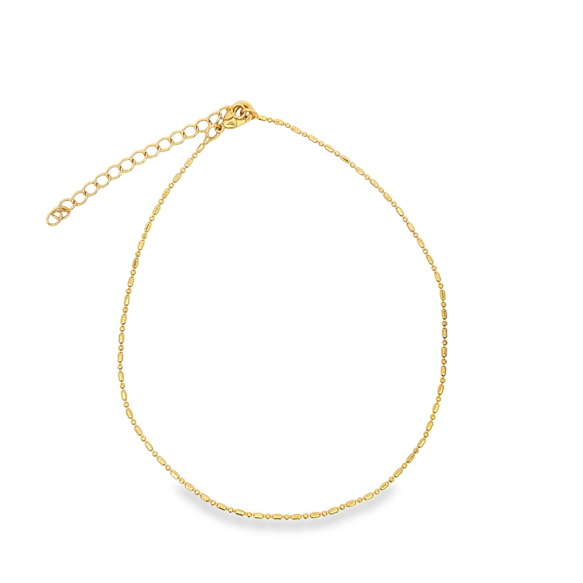 A delicate gold beaded necklace rests gracefully against a white background, highlighting its intricate chain and adjustable clasp.