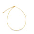A delicate gold beaded necklace rests gracefully against a white background, highlighting its intricate chain and adjustable clasp.