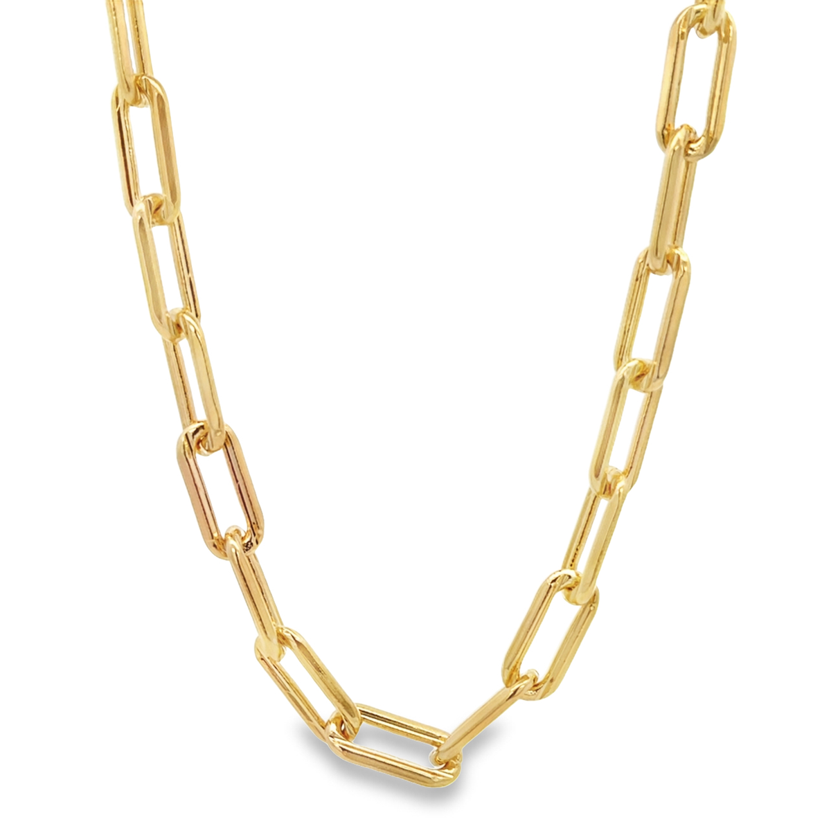 A polished gold paperclip chain necklace rests against a clean white background.