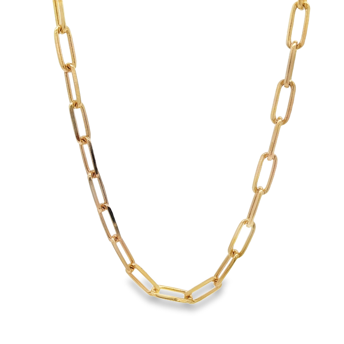 A polished gold paperclip chain necklace drapes elegantly against a clean white background.