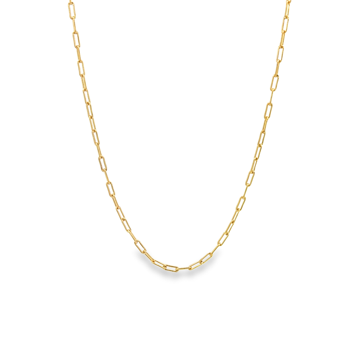 A delicate gold paperclip chain necklace drapes against a clean white background.