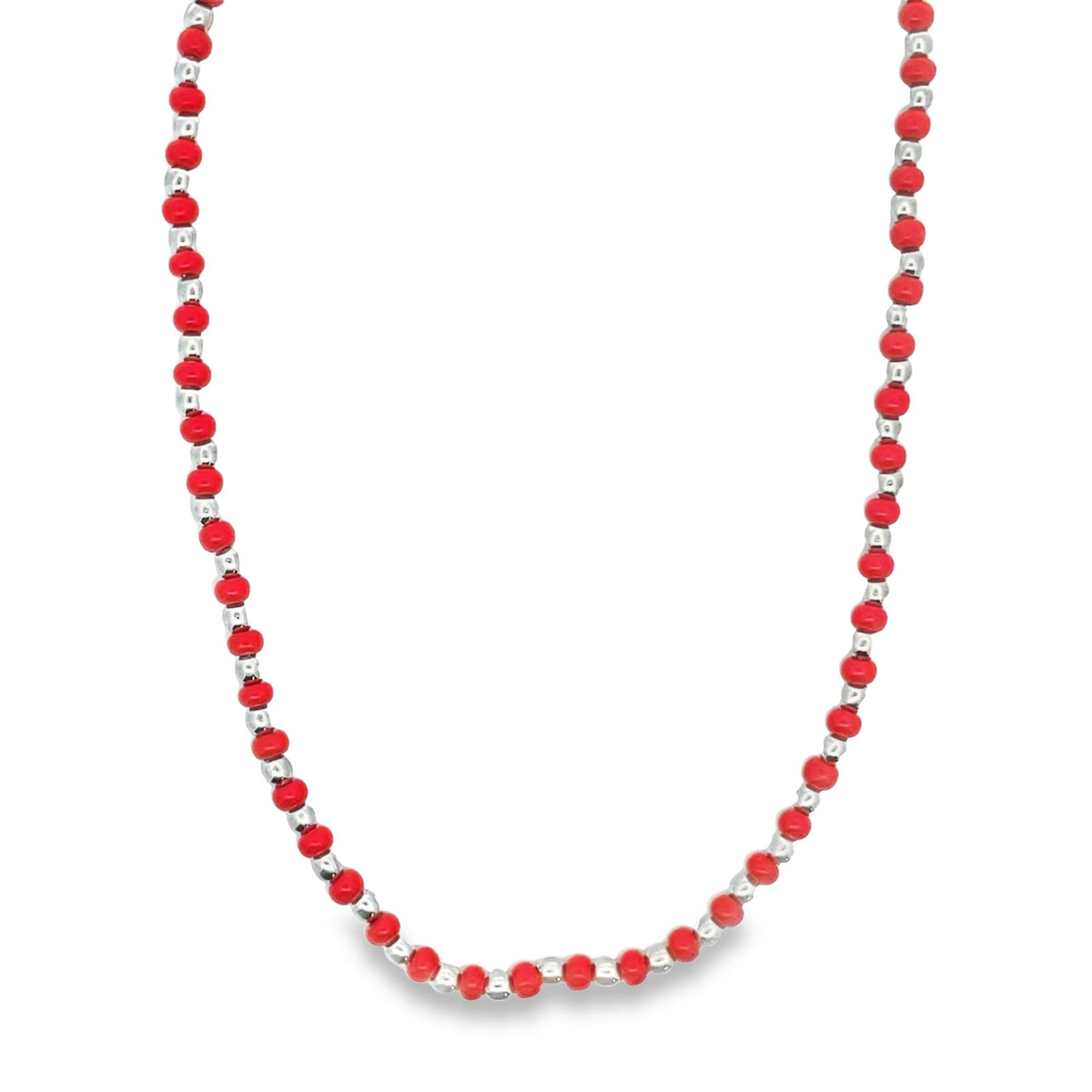 A vibrant red beaded necklace features alternating silver spacer beads along its length.