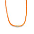 A bright orange beaded choker necklace features a central gold charm against a plain white background.