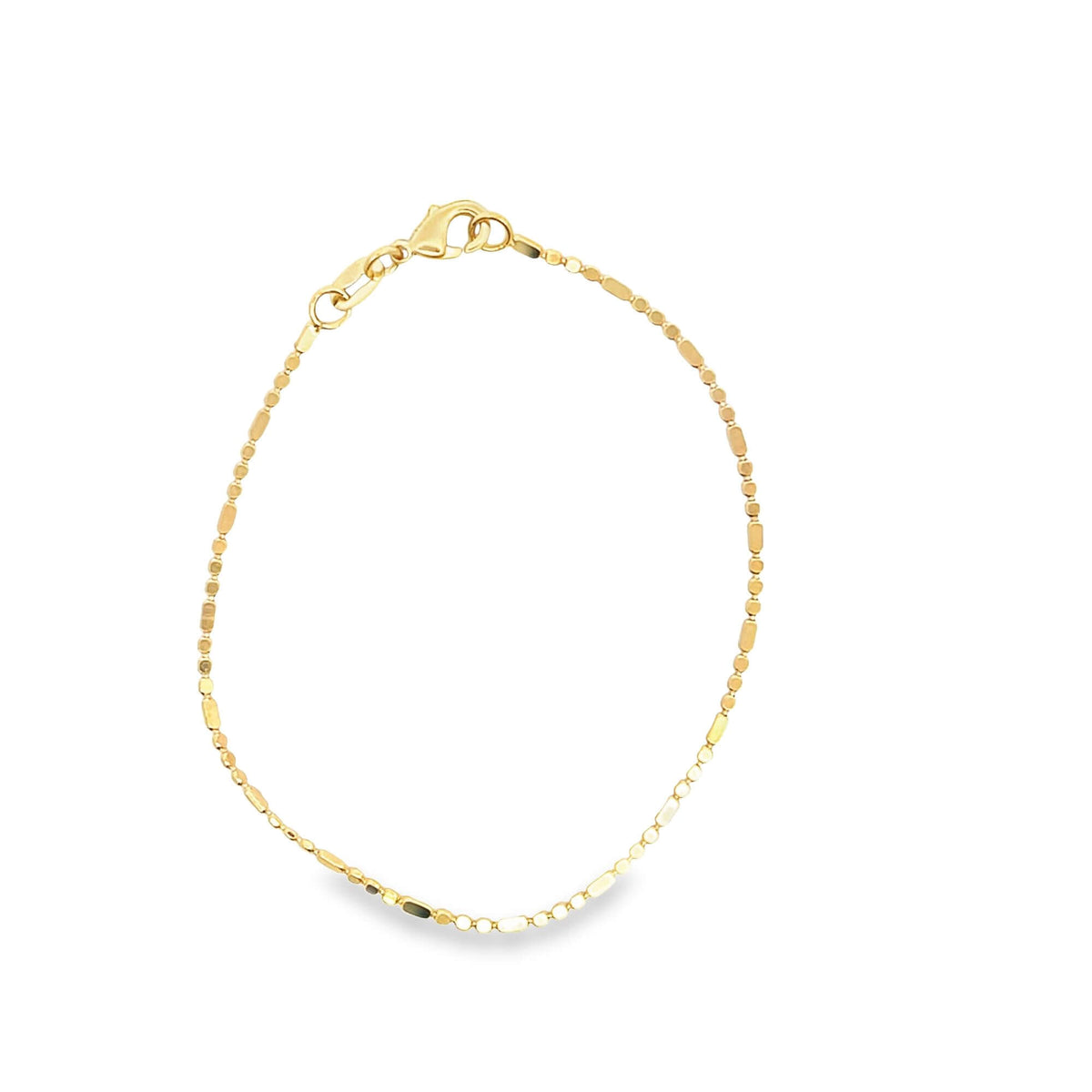 A delicate gold bead chain bracelet rests against a clean white background.