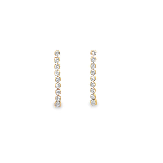 A pair of gold diamond line drop earrings sparkles against a clean white background.
