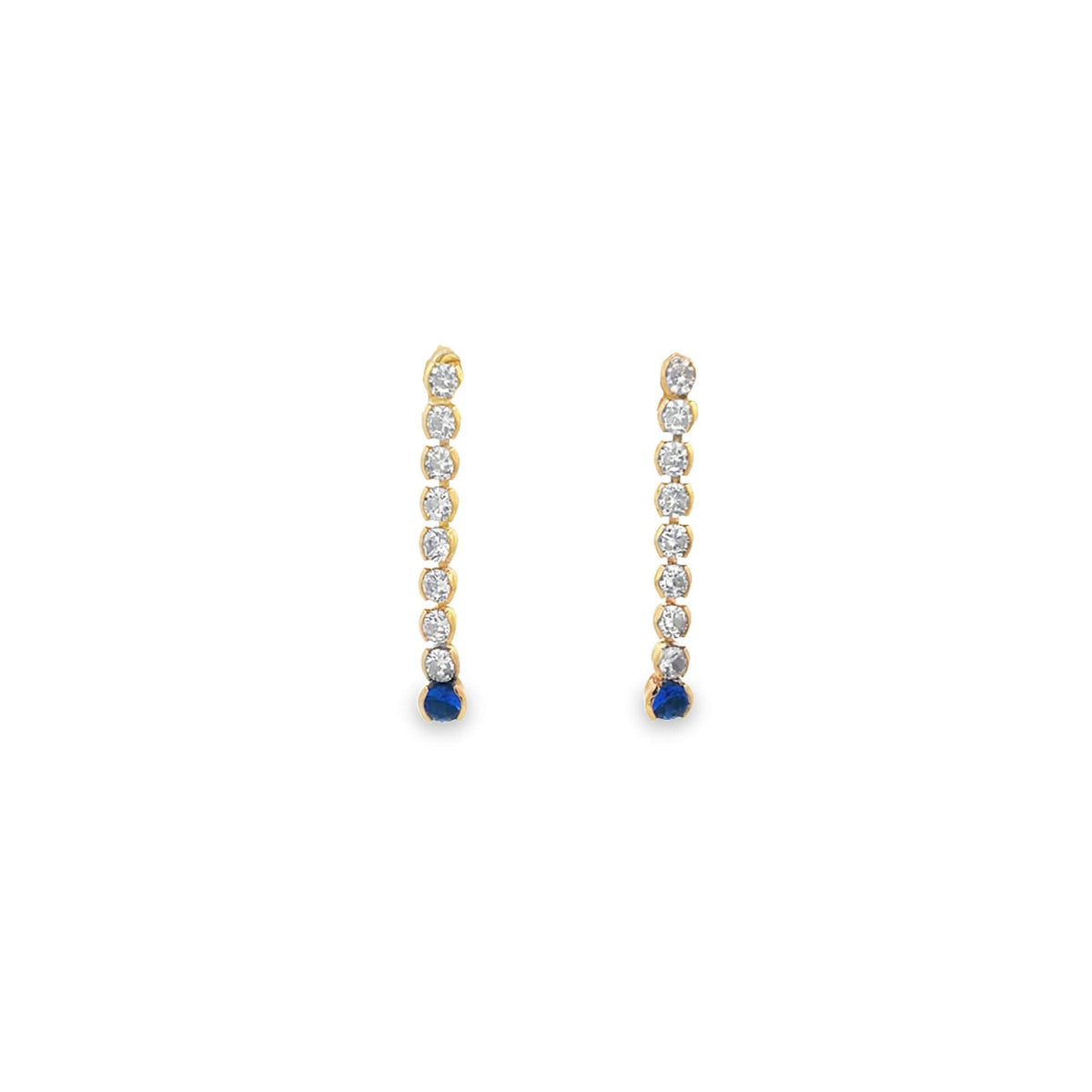 A pair of gold drop earrings features a vertical line of sparkling diamonds ending in a vibrant blue sapphire.
