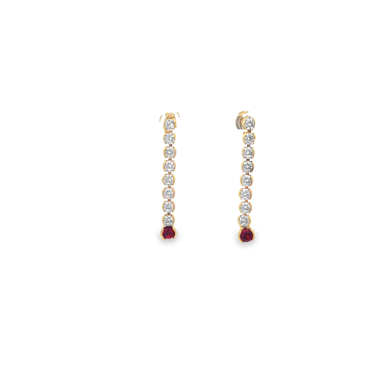 A pair of gold drop earrings features a vertical line of sparkling diamonds ending in a vibrant red gemstone against a clean white background.