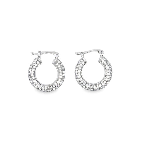 A pair of sparkling silver pave hoop earrings rests against a clean white background.