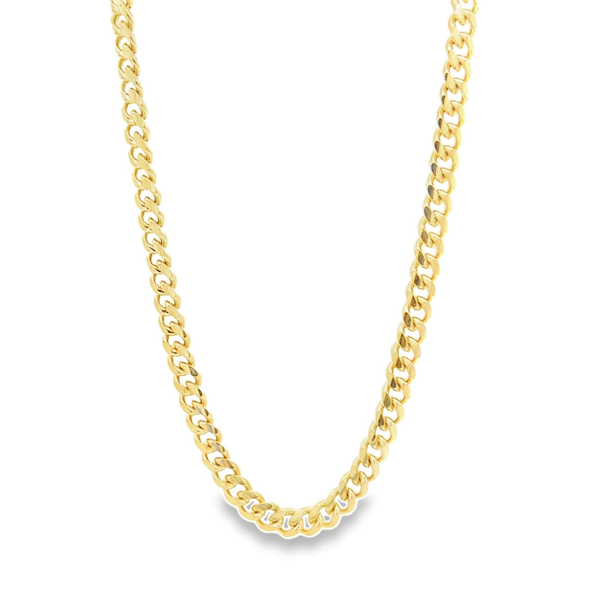 A polished gold cuban link chain necklace drapes against a clean white background.