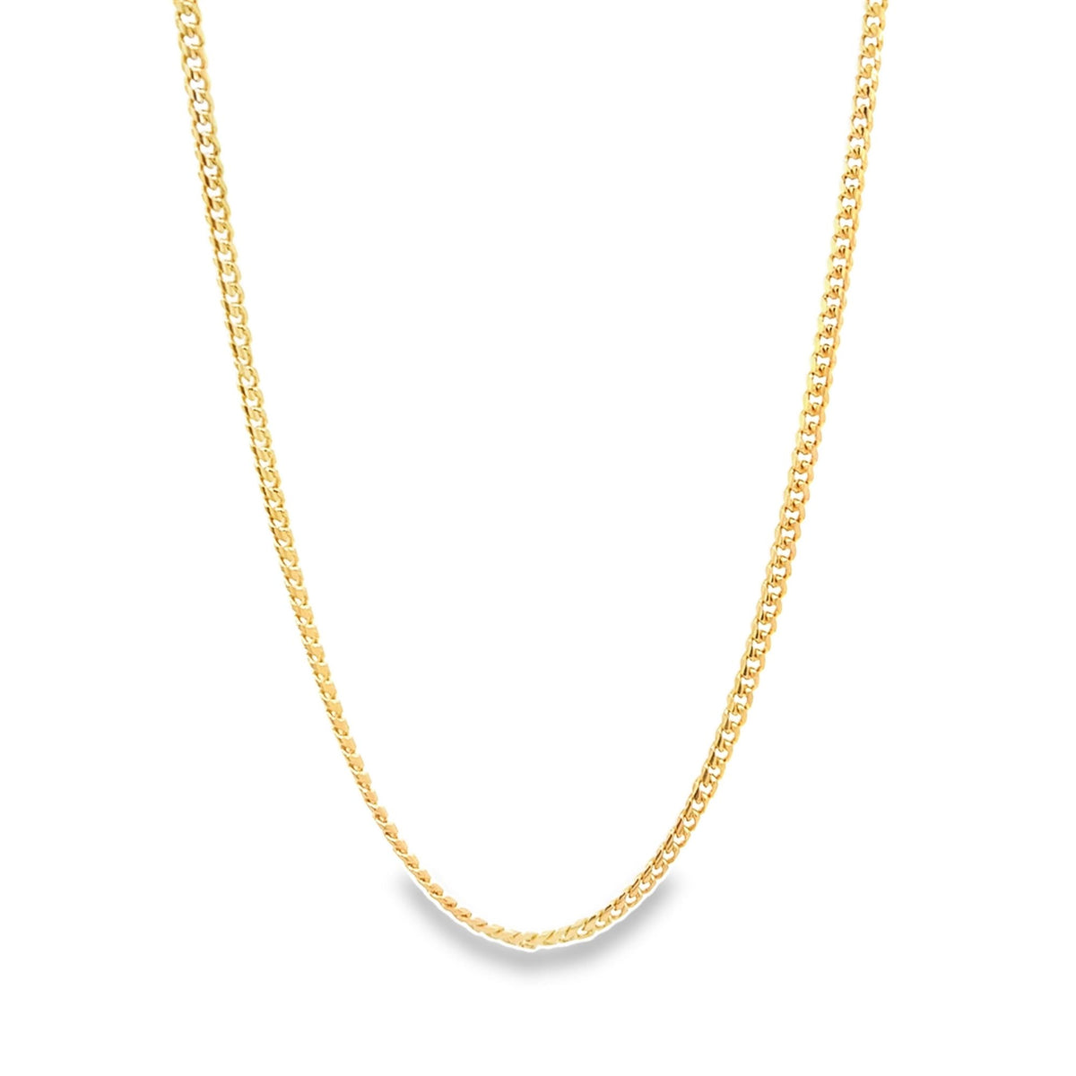 A polished gold cuban link chain necklace drapes elegantly against a clean white background.