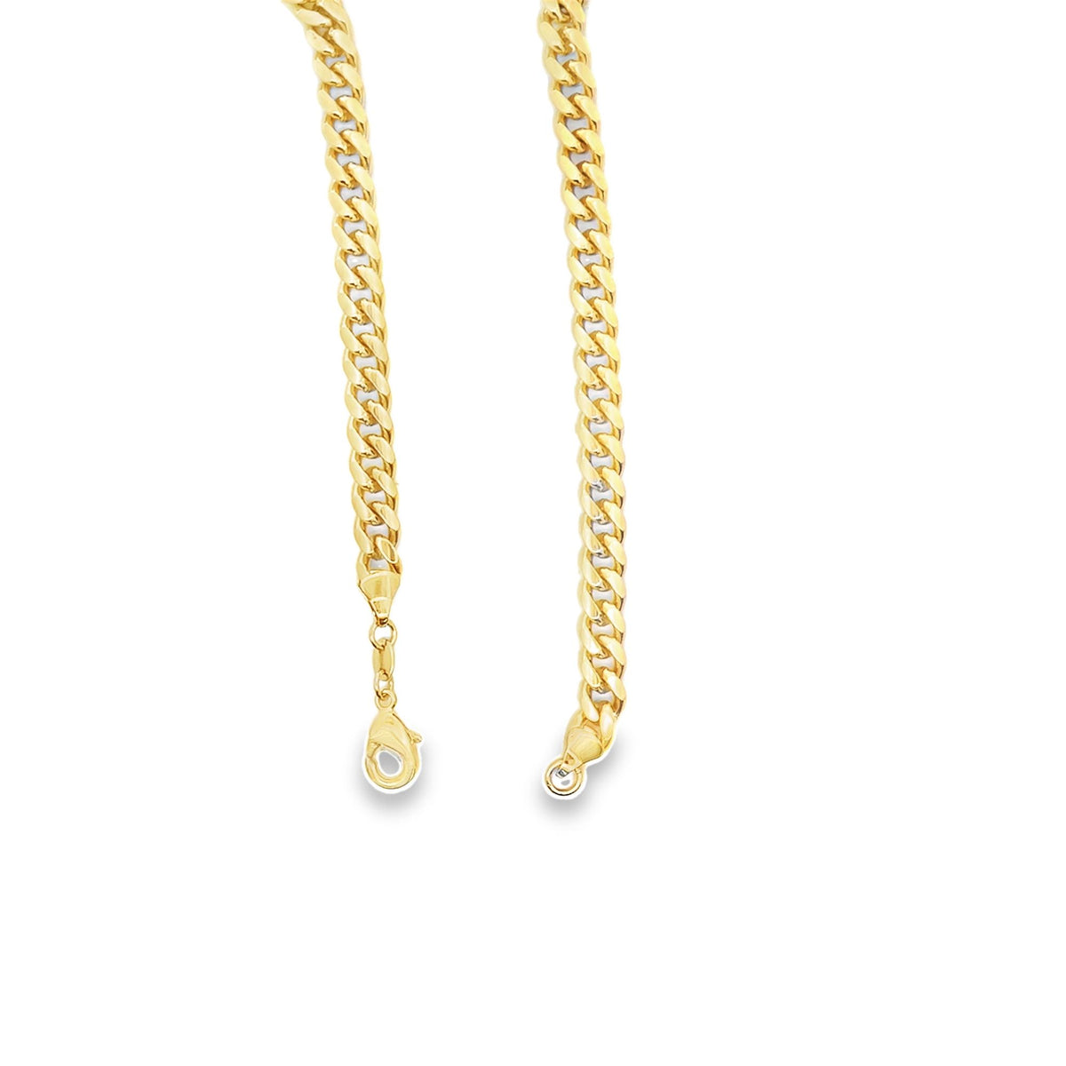 A polished gold cuban link chain drapes vertically against a clean white background, showcasing its intricate interlocking links and secure lobster clasp.