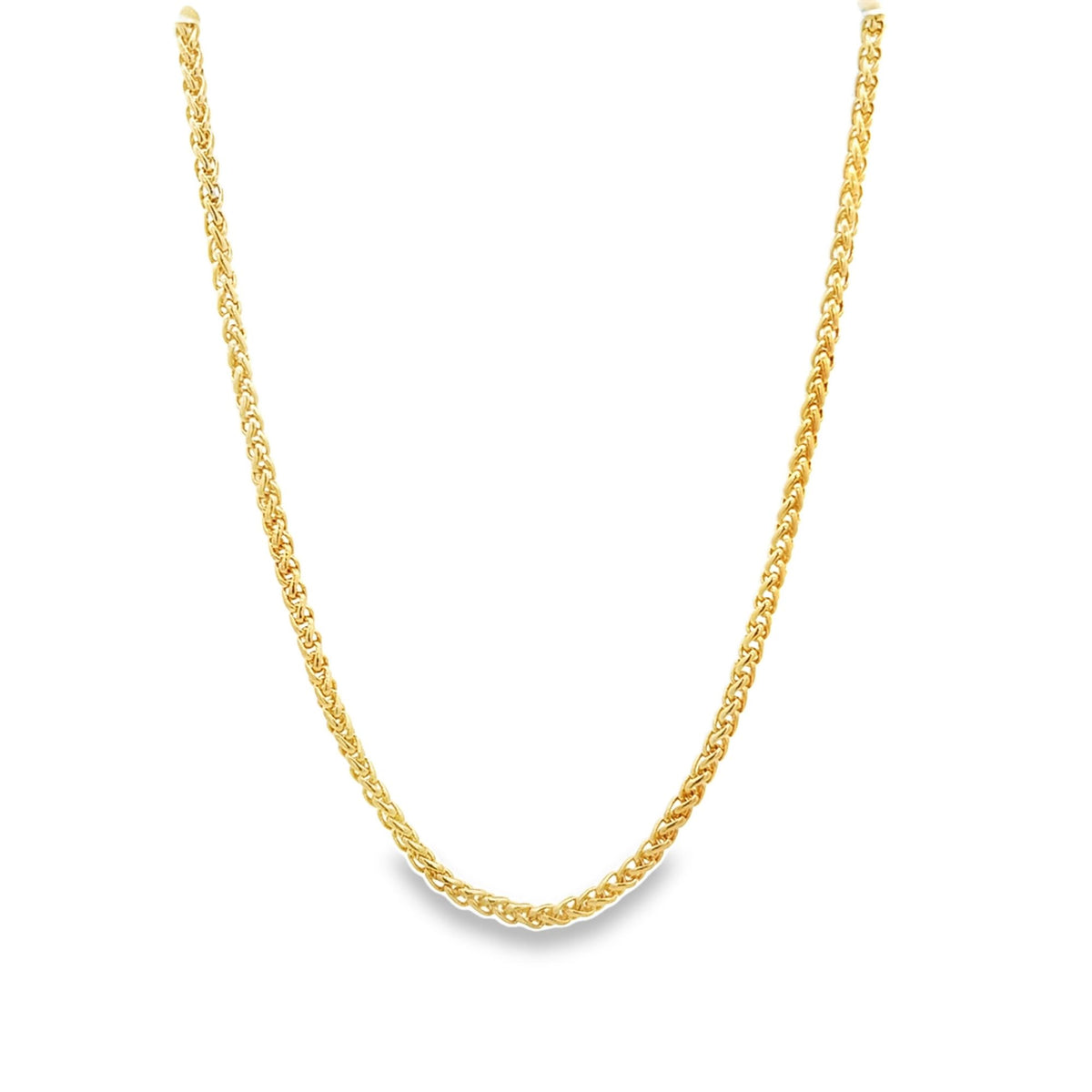 A delicate gold chain necklace drapes in a graceful curve against a clean white background.