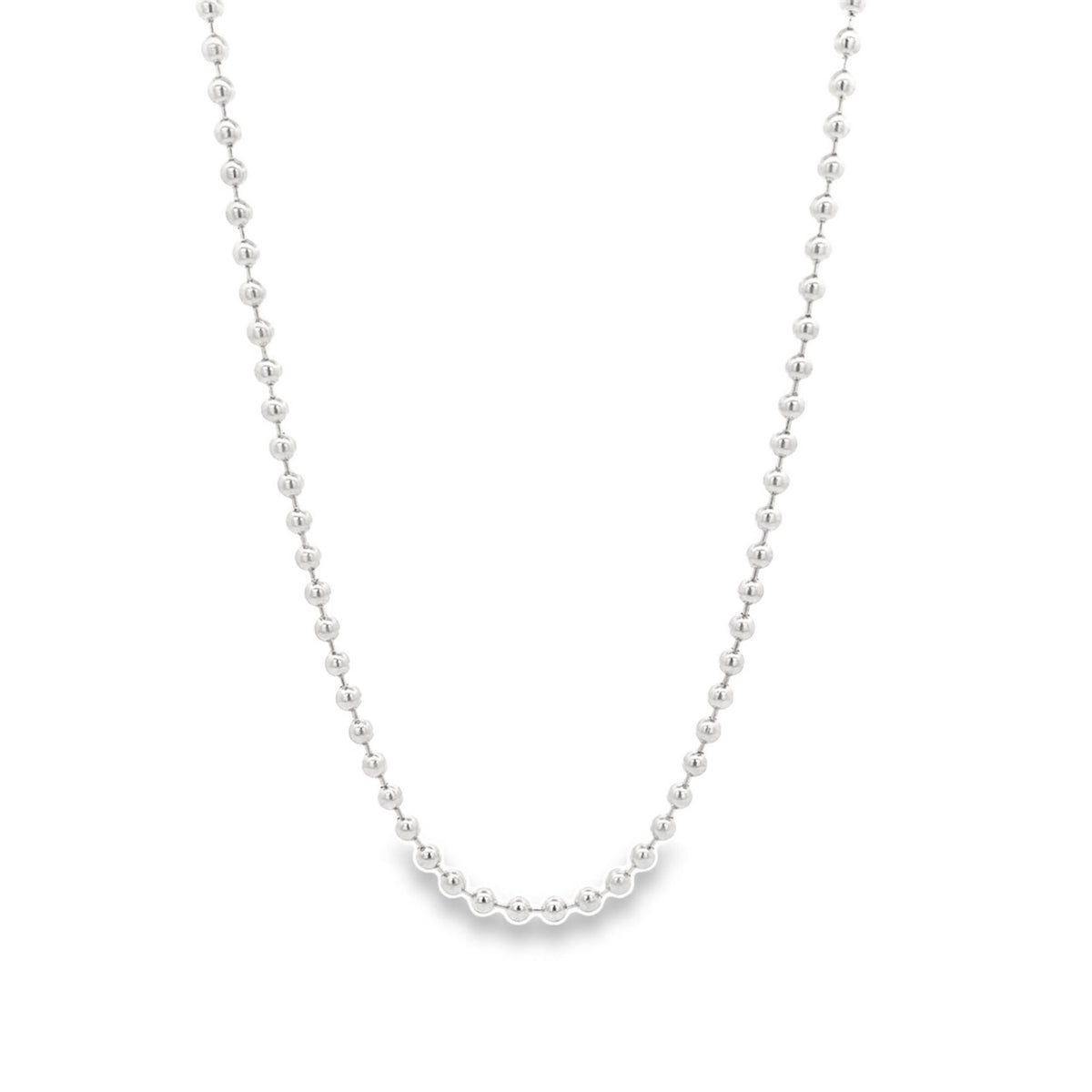 A sleek sterling silver ball chain necklace hangs in a graceful curve against a clean white background.