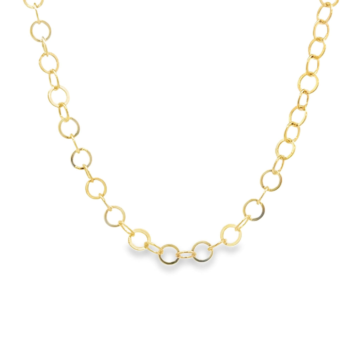 A delicate gold chain necklace drapes gracefully against a plain white background, showcasing its interlocking circle links.