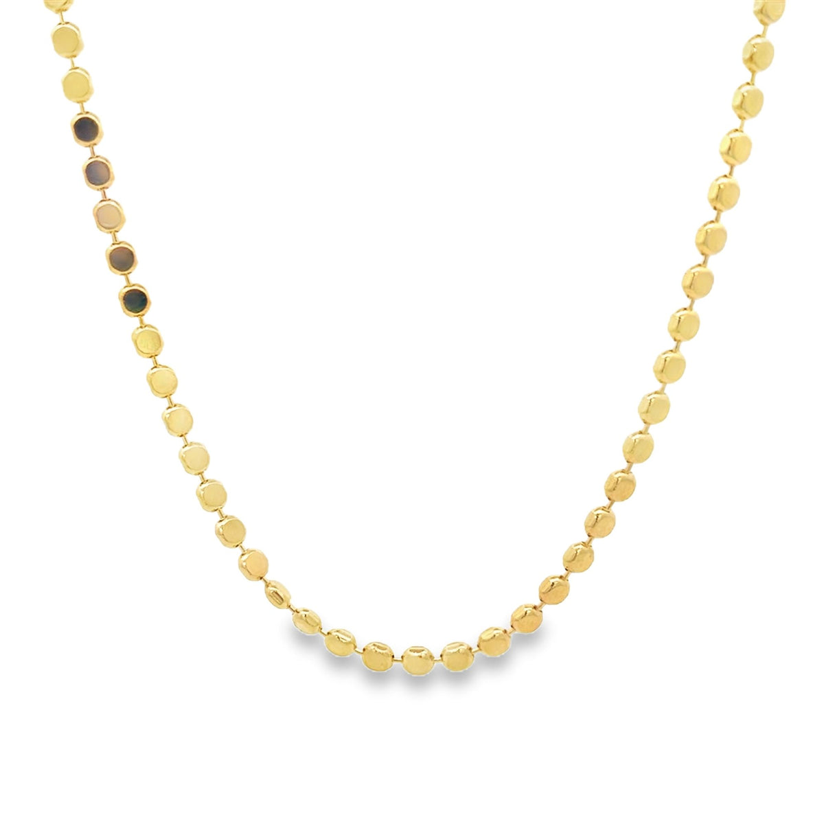 A delicate gold chain necklace features evenly spaced, flat round coin links.
