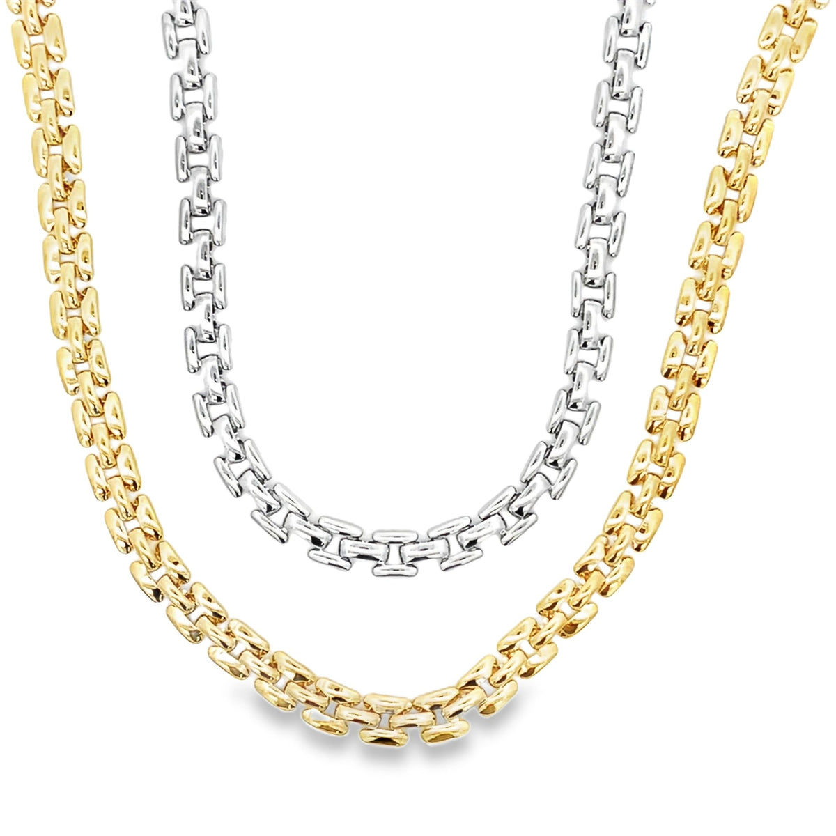 Three intertwined chunky link chains in yellow gold and silver display distinct textured patterns against a clean white background.