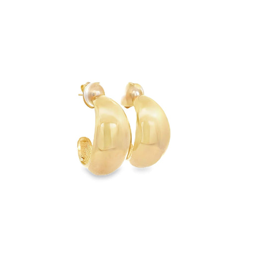 A pair of polished gold hoop earrings resting against a clean white background.