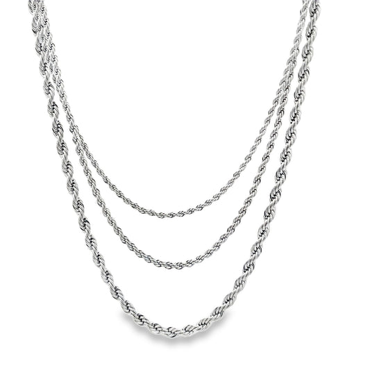 A layered silver rope chain necklace drapes gracefully against a clean white background.