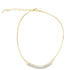 A delicate gold chain necklace sparkles with a curved row of cubic zirconia stones at the center.