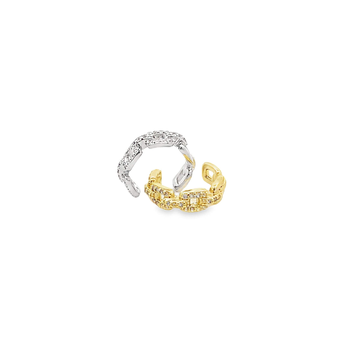 Two interlocking gold and silver chain-link ear cuffs sparkle with pave-set crystals against a clean white background.