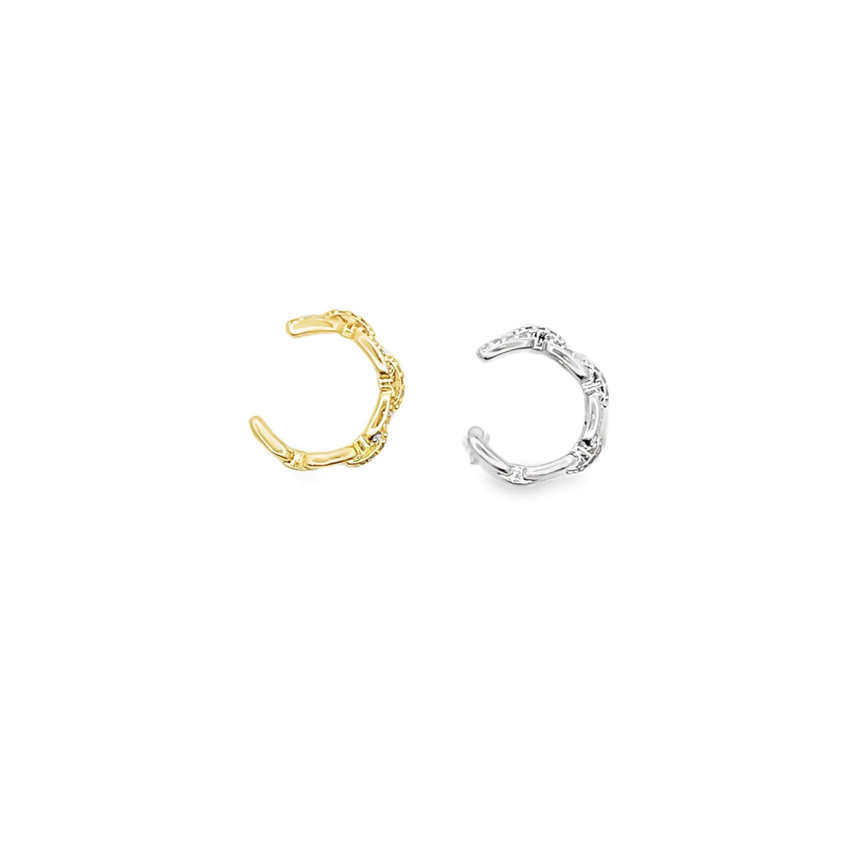 A pair of textured gold and silver ear cuffs lie side by side on a clean white background.