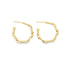 A pair of gold hoop earrings features an intricate, interlocking link design against a clean white background.